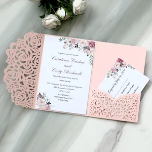 Detail view of pink laser-cut rose wedding invitation with elegant floral card