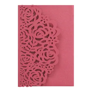 Detailed view of the intricate laser-cut rose floral pattern on pink shimmer wedding card