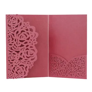 Detail of rose laser-cut wedding invitation card in elegant pearlescent pink paper