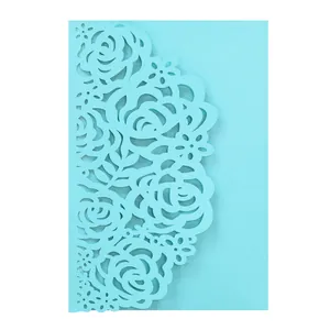 Macro detail showing the light blue laser-cut rose pattern on the invitation card