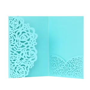 Close-up of intricate laser-cut rose floral pattern on tiffany blue invitation card