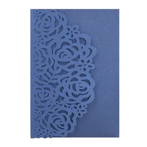 Detailed view of navy blue laser-cut rose floral invitation card with glitter texture.
