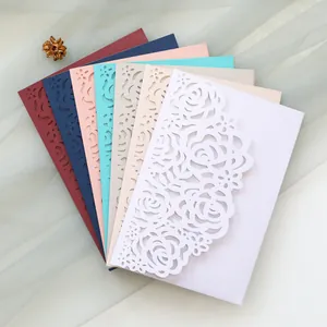 Detailed view of laser-cut rose invitation cards in various colors arranged in a fan