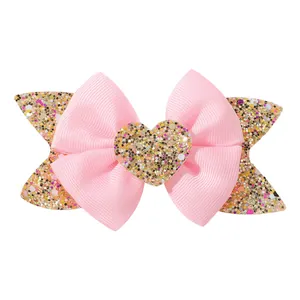 Barrette à nœud en ruban gros-grain rose pour filles avec un cœur à paillettes dorées