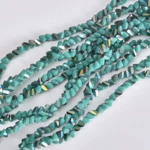 Close-up of 4mm triangular electroplated teal crystal beads for DIY jewelry