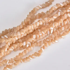 Macro detail of 4mm faceted champagne triangular crystal beads for DIY jewelry