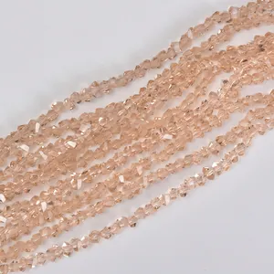 Close-up detail of 4mm champagne triangular faceted crystal glass beads for DIY jewelry.