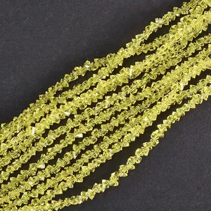 Macro detail of 4mm faceted yellow crystal beads for DIY jewelry making