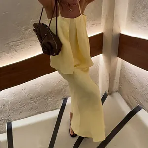 Elegant pale yellow camisole top and slim fit maxi skirt two-piece set for summer