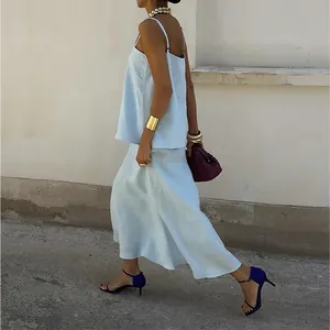 Elegant light blue two-piece set with camisole top and flowy midi skirt for summer