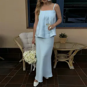 Elegant light blue two-piece camisole and long skirt set shown in an outdoor setting.