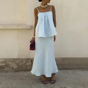 Elegant light blue summer two-piece set featuring a camisole top and long flowy skirt