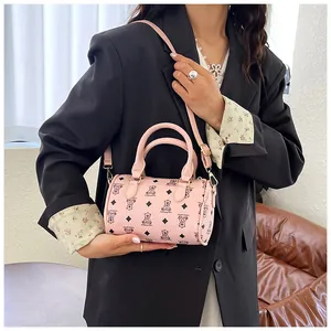 Detail of pink mini barrel bag featuring cute bear print and sturdy top handles