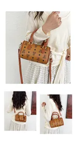Detail of a brown monogram Boston bag with teddy bear pattern and shoulder strap