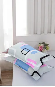 Close-up detail of envelope style pillowcases with pink and blue geometric patterns