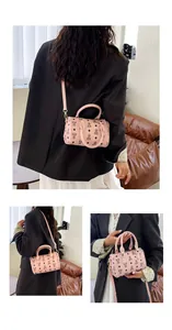Detailed close-up views of a stylish pink barrel bag with bear pattern worn by a model.