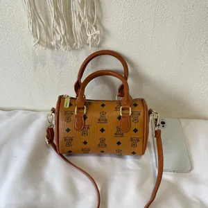 Classic brown barrel handbag with cute bear pattern and diamond print details