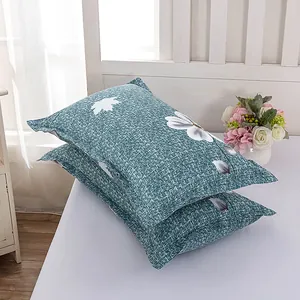 Detail showing the fabric texture and white floral print on modern teal pillowcases