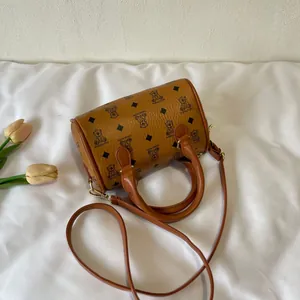 Detailed macro view of a cute cartoon bear printed barrel handbag in brown leather finish