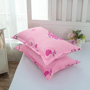 Pink pillowcase pair with white polka dots and heart patterns for bedroom decor.