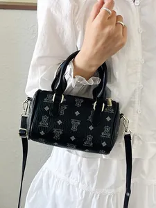 Elegant black barrel handbag for women featuring cute bear patterns and shoulder strap