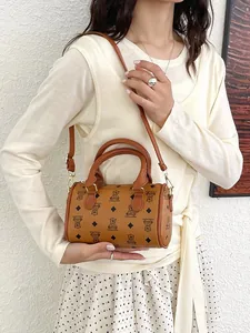 Trendy brown barrel handbag with cute bear print pattern and adjustable strap for women