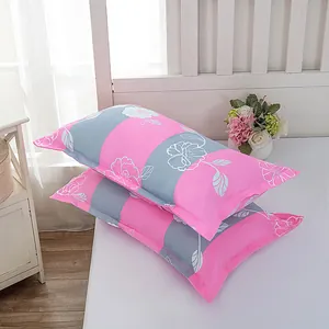 Detailed view of pink and gray striped pillowcases with elegant white floral patterns