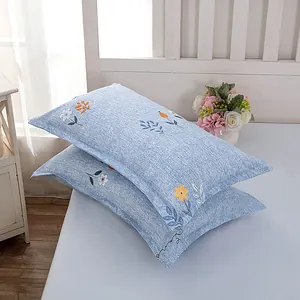 Detail of blue cotton-feel pillowcases with elegant floral pattern for home decor