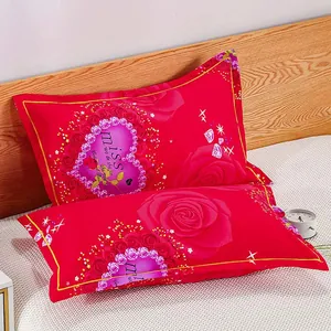 Detail view of a pair of red pillowcases with rose and heart patterns