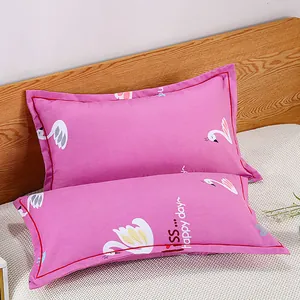 Close-up of modern pink pillowcases with swan patterns and happy day decorative text