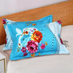 Close-up detail showing a pair of light blue pillowcases with vibrant floral patterns on a bed