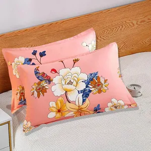 Detailed macro view of pink floral pillowcase pair with elegant lily patterns on a cozy bed