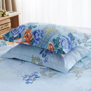 Close-up detail of blue floral and paisley pattern on a stacked pair of soft pillowcases