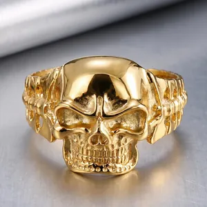 Macro view of a gold-plated punk skull ring with detailed hollow eye sockets