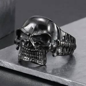 Close-up detail of a gothic punk style black stainless steel skull ring for men