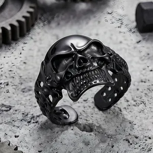 Detailed macro view of a black stainless steel punk skull ring with intricate gothic carvings