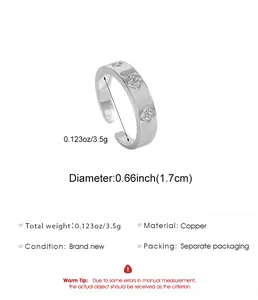 Detailed view of silver-tone copper ring with zircon clover patterns and dimensions