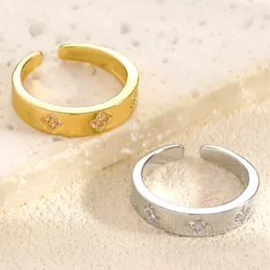 Close-up of gold and silver stainless steel rings with zircon flower pattern