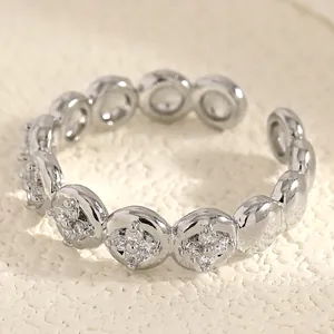 Macro view of a polished silver stainless steel open ring with sparkling zircon stones