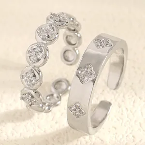 Close-up detail of stainless steel stacking rings featuring zircon flower engravings