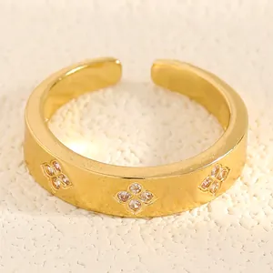 Macro detail of gold-plated ring showing intricate flower patterns with zircon inlay