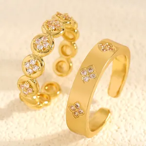 Close-up detail of gold stainless steel rings featuring elegant zircon clover patterns