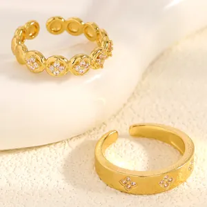 Macro detail of golden stainless steel stackable rings with zircon flower engraving