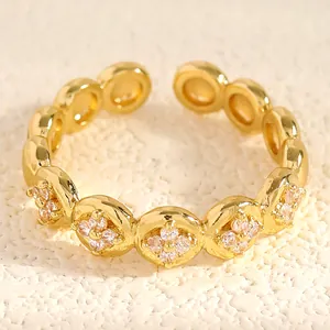 Detailed close-up of gold stainless steel open ring with cubic zirconia floral engraving