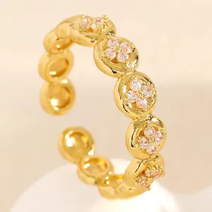 Macro detail of the gold stainless steel ring featuring exquisite zircon floral patterns
