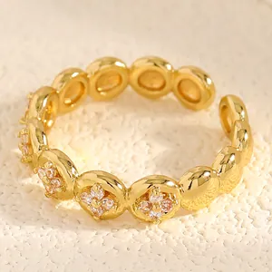 Macro view of gold stainless steel ring with pink zircon floral pattern detail