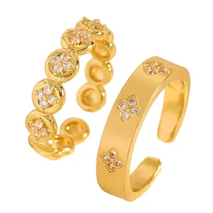 Macro detail of gold plated stainless steel rings with zircon flower pattern settings