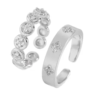 Close-up detail of silver stainless steel rings with engraved clover and zircon details