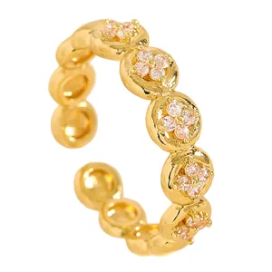 High-quality macro view of gold stainless steel ring with delicate flower zircon inlays