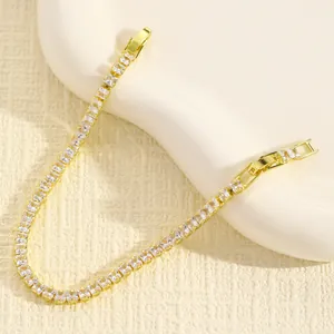 Dettaglio macro di cristalli a taglio quadrato su un bracciale tennis placcato oro
